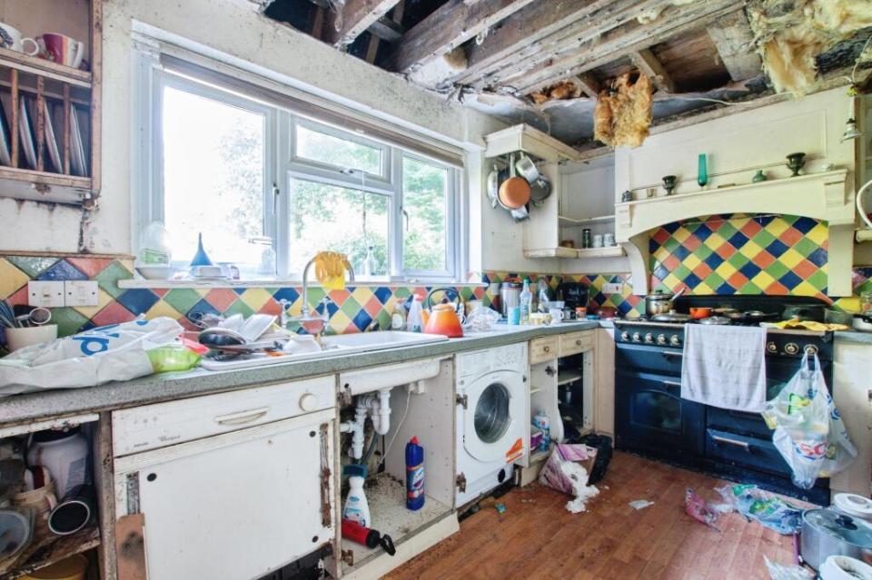 Messy kitchen in a dilapidated house needing refurbishment.