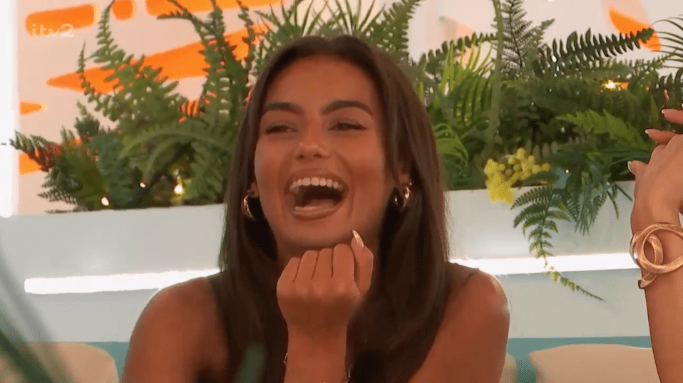 Screenshot of a laughing woman.