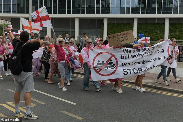 A sign held up at the mostly women's protest reads 'Don't gamble with our lives: Stop the boats'