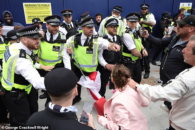 Demonstrators at today's protest in Canary Wharf clash with police officers