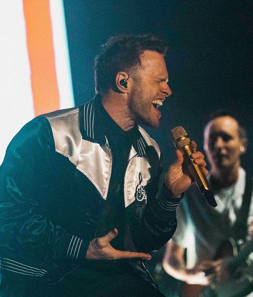 Olly Murs performing on stage.