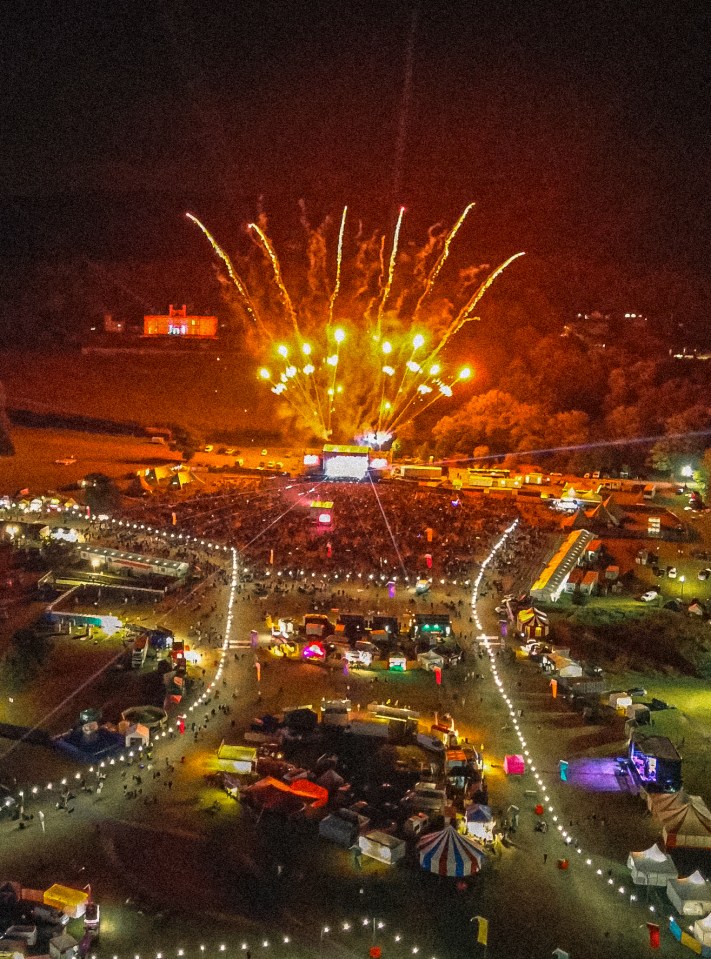 Aerial view of Together Again Festival with fireworks over the crowd.