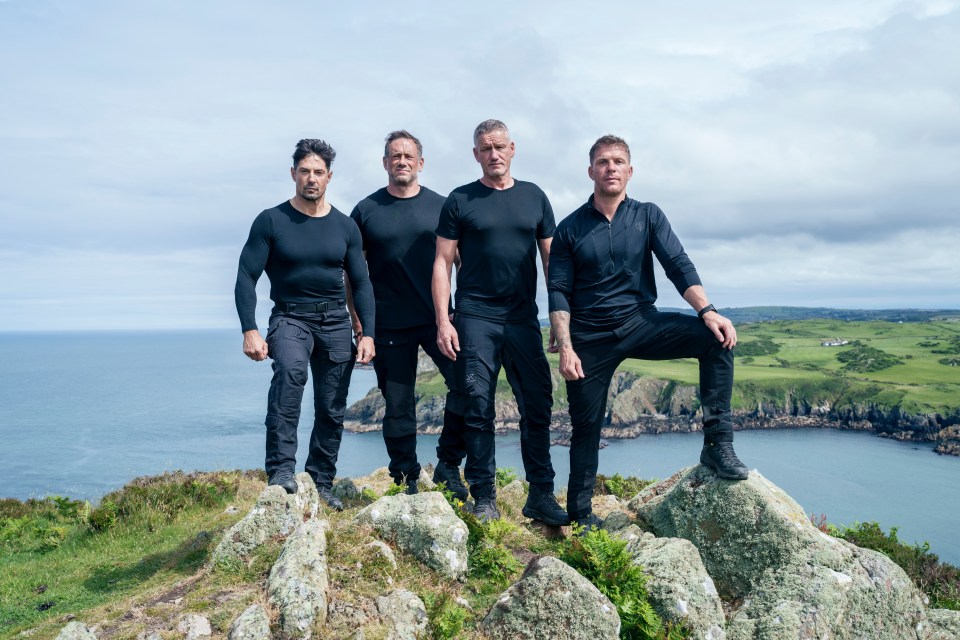 Four Special Forces training instructors standing on a cliff overlooking the ocean.