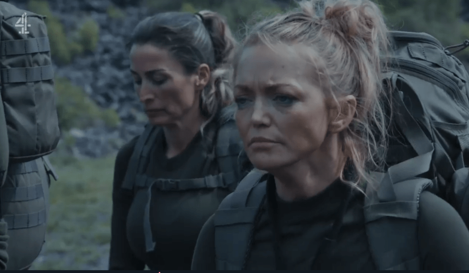 Two women in military uniforms carrying backpacks.
