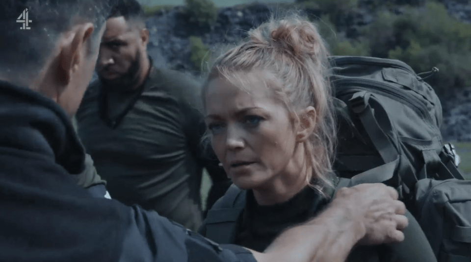 A woman with a backpack is comforted by a man.