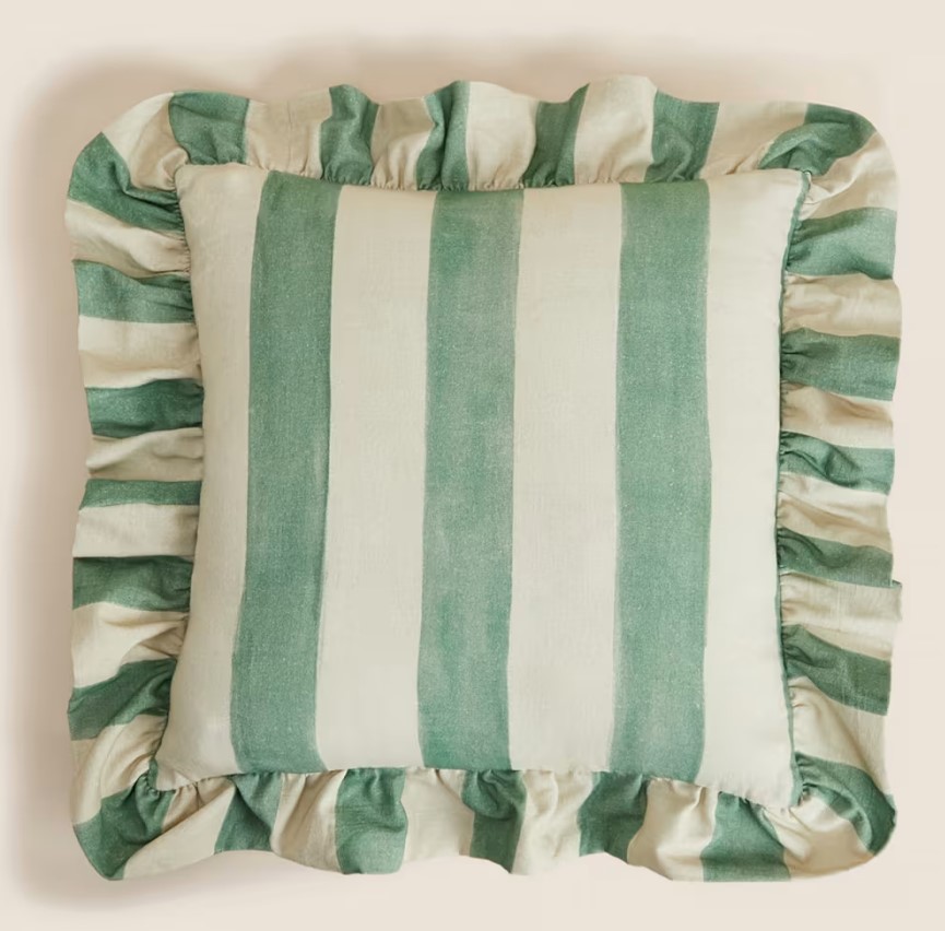 Green and beige striped pillow with ruffled edges.