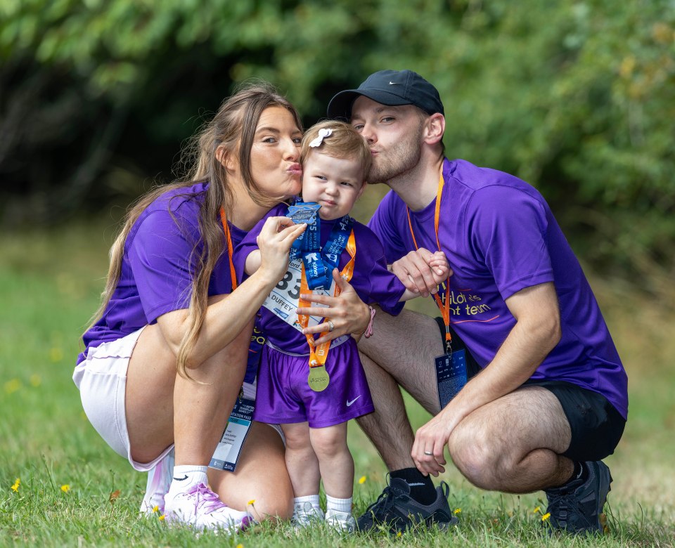 Family at British Transplant Games; young girl with medal.