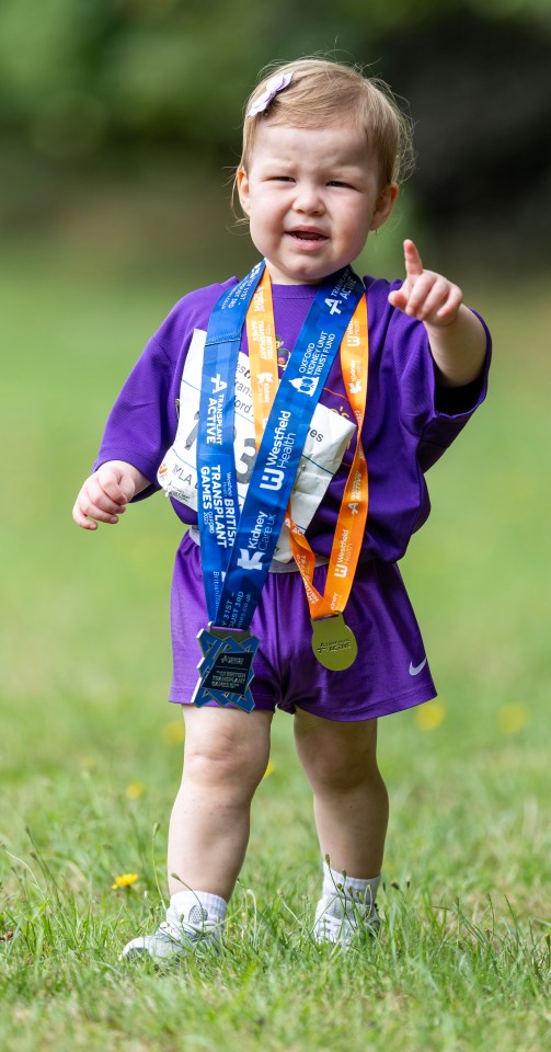 Toddler with medals at the British Transplant Games.