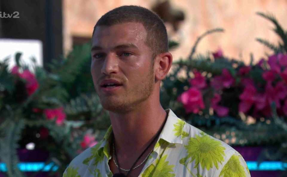 Man in floral shirt announcing Love Island elimination.