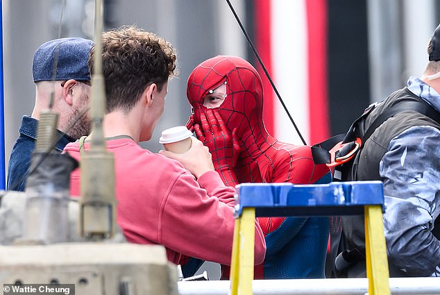 Tom's eyes were spotted below the iconic Spider-Man suit as he got into full character