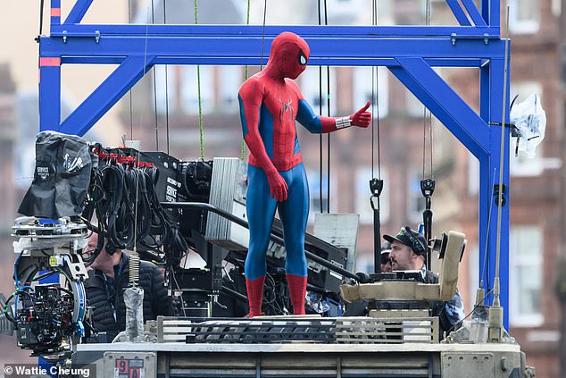 Tom gave a thumbs up to crew as he stood on top of a tank for the action-packed scene