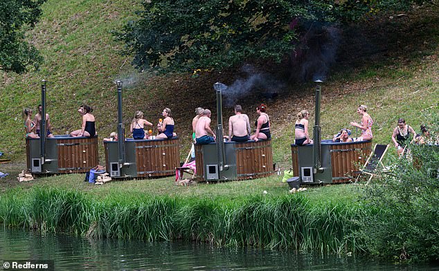 Festivalgoers relaxed and soaked up the atmosphere in the outdoor hot tubs on the first day of Britain's most middle class festival