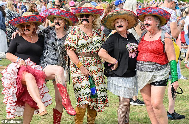 Pictured: festival goers adorn moustaches on day one of the popular festival
