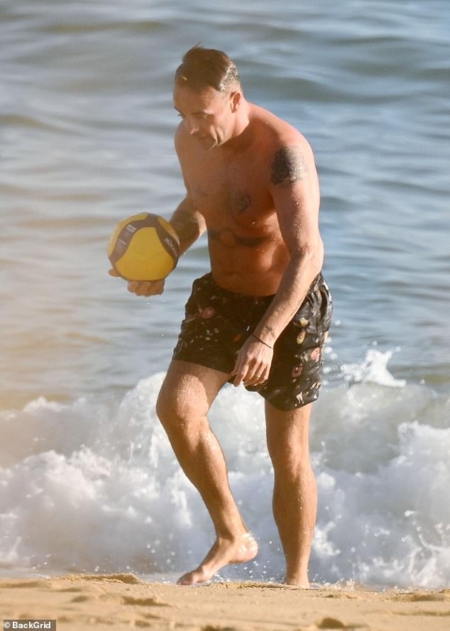 The couple were seen playing ball games on the beach