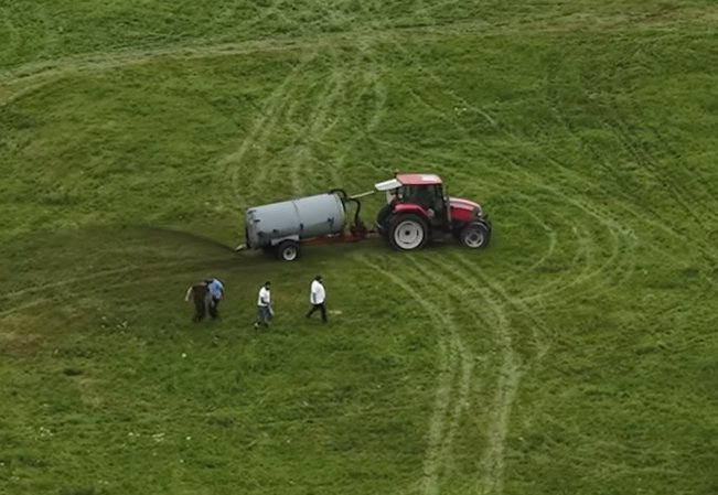 Members of the community are pictured rushing to stop the tractors