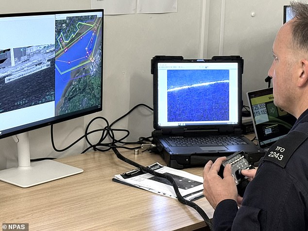 The National Police Air Service (NPAS) is hoping the remotely-piloted aircraft will be able to join its helicopter fleet in the future to carry out searches for criminals and missing people. Pictured: Pilot remotely controlling the aircraft