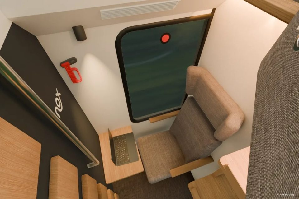 Illustration of a private train room with a seat, small table, and laptop.