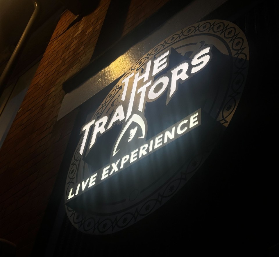 Lit sign for The Traitors Live Experience.