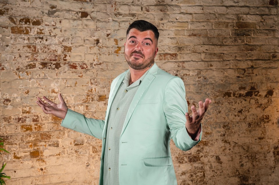 Luke Worley in a mint green suit, gesturing with his hands.
