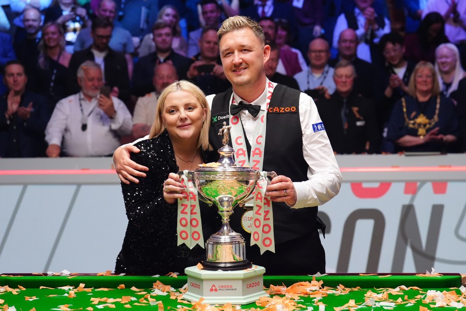 Kyren Wilson and his wife celebrating a snooker championship win.