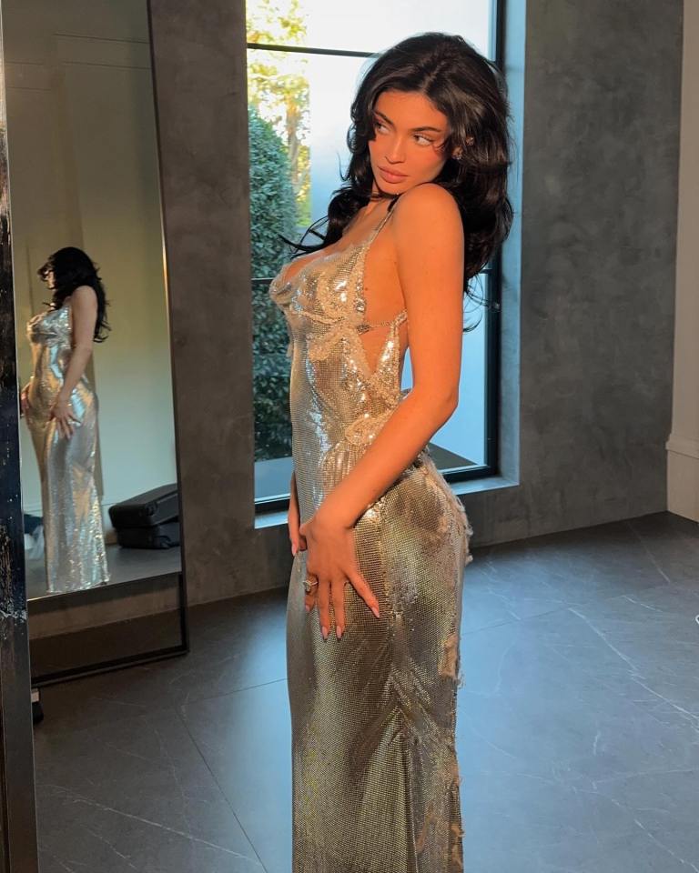 Woman in a silver chainmail dress.