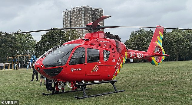 It is understood the child has not sustained life threatening injuries and no arrests have been made (Pictured: An air ambulance at the scene)