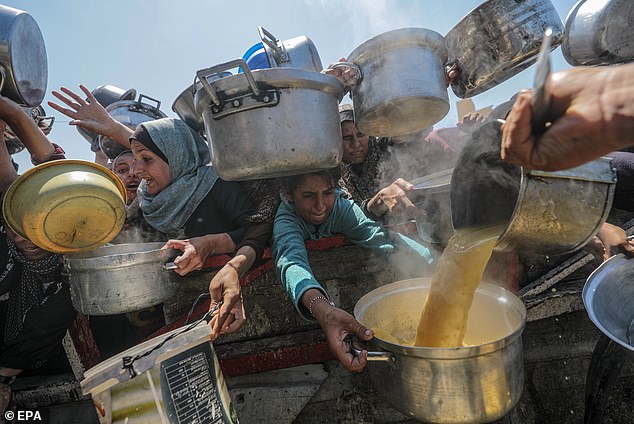 Food is distributed to Palestinians as both Hamas and Israel blame each other for the humanitarian crisis in Gaza