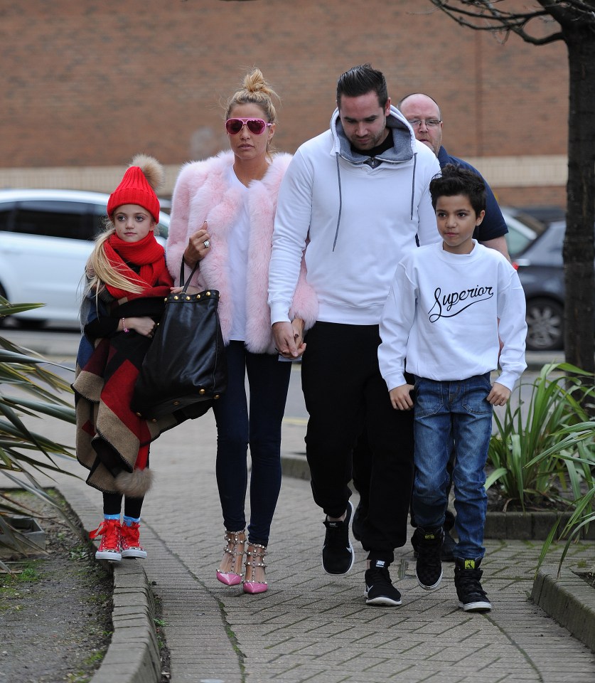 Katie Price and Kieron Hayler walking with their children.