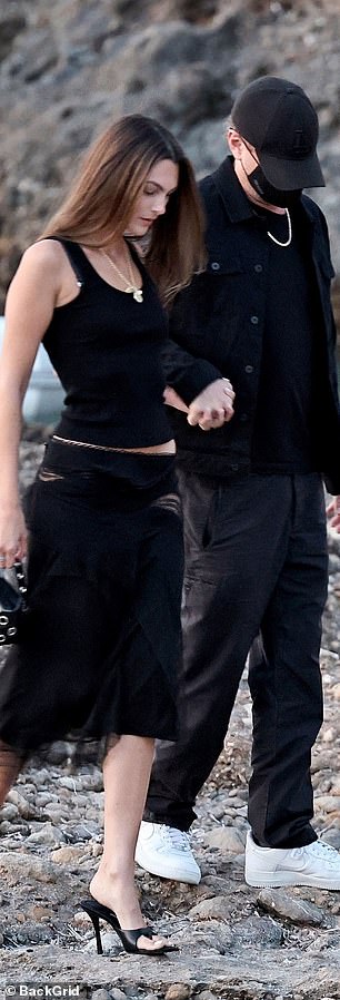 The Italian model, 27, kept it simple in a black vest top and low waisted black skirt with mesh detailing