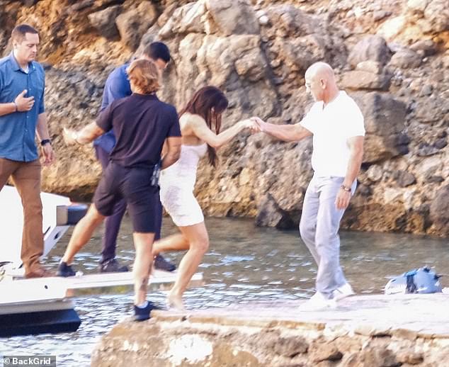 Lauren was snapped taking a leap off the boat with the help of her husband