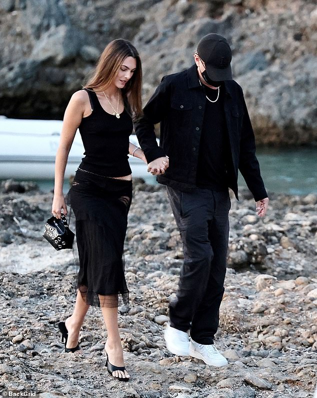 Leonardo appeared to wish to keep a low profile as he concealed his face with a black facemask and baseball cap