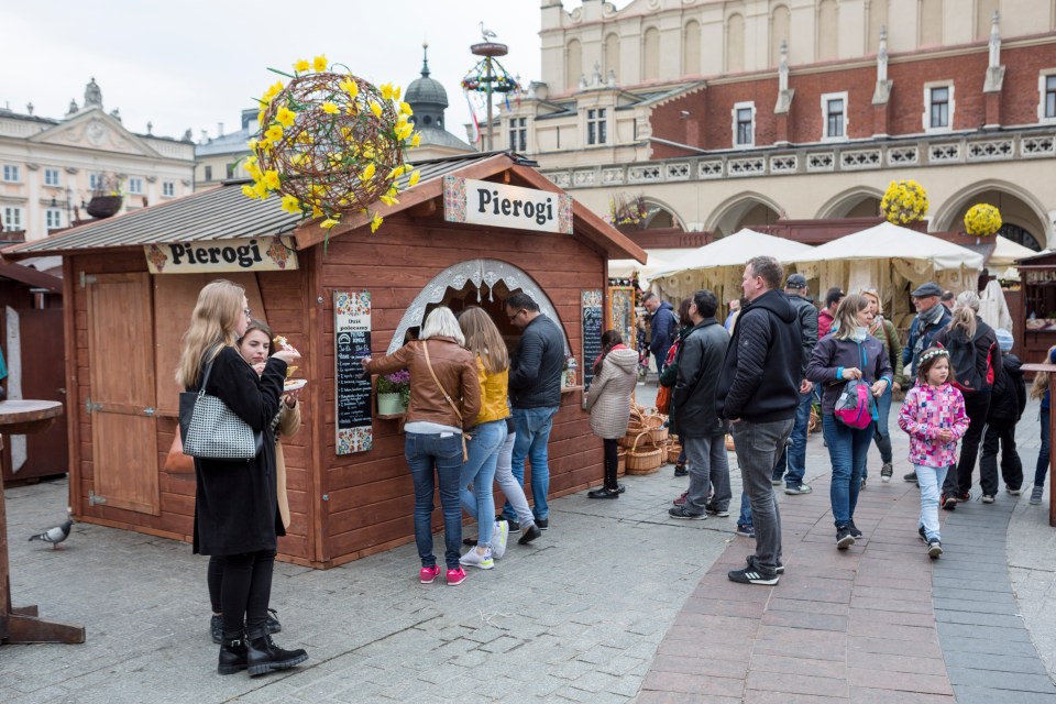 People enjoying pierogi at an Easter festival in Krakow's main square.