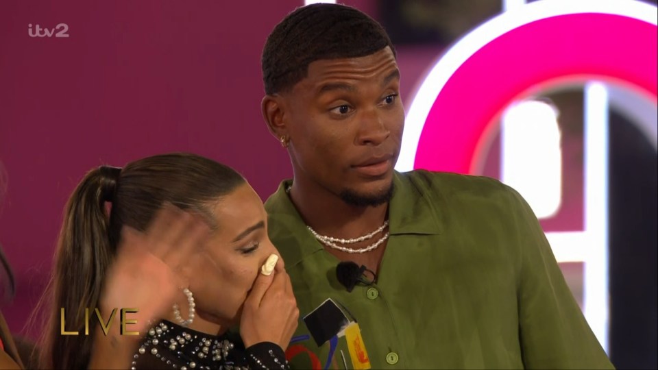 Screenshot of a man and woman during a live TV show; the woman is crying.