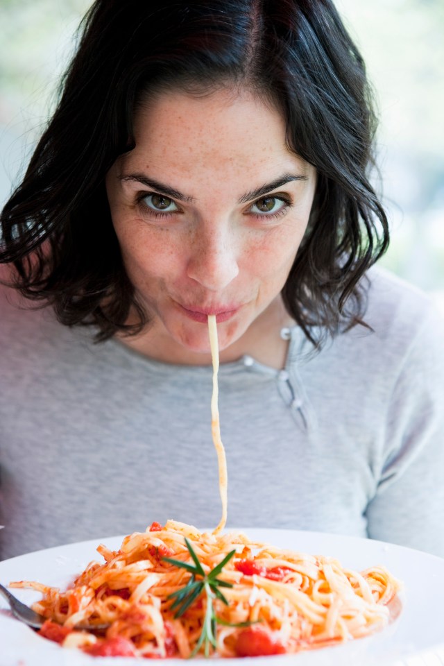 Woman eating spaghetti in Berlin.