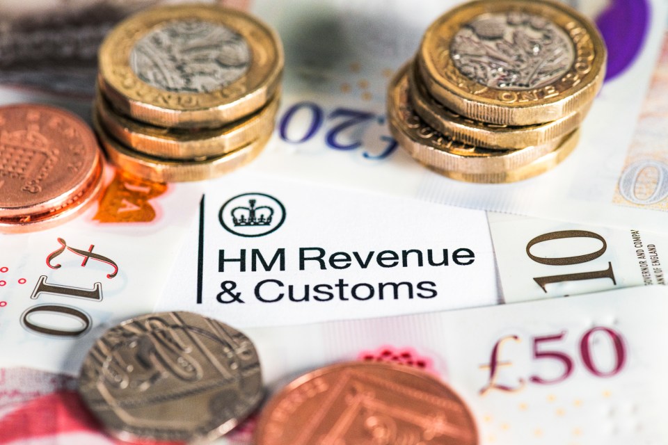 British banknotes and coins surrounding an HM Revenue & Customs tax form.