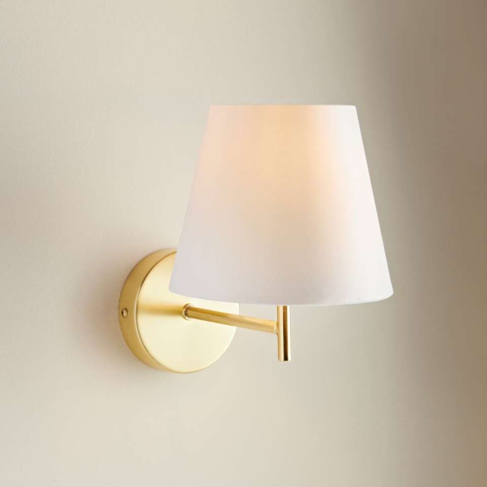 Gold wall-mounted lamp with white shade.