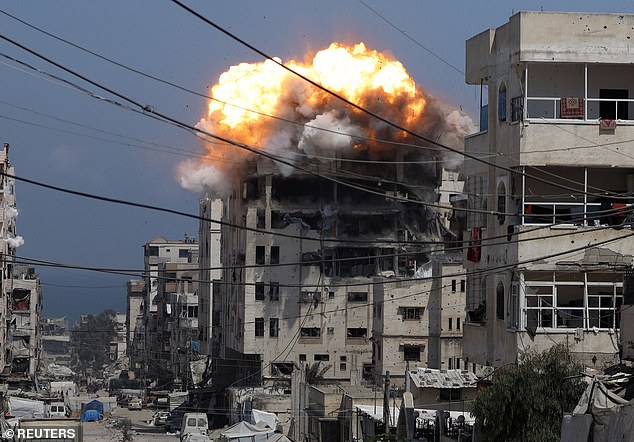 Smoke and flames rising from an apartment complex hit by an Israeli strike. The prime minister is said to have told his military chief to resign if he does not agree with his decision