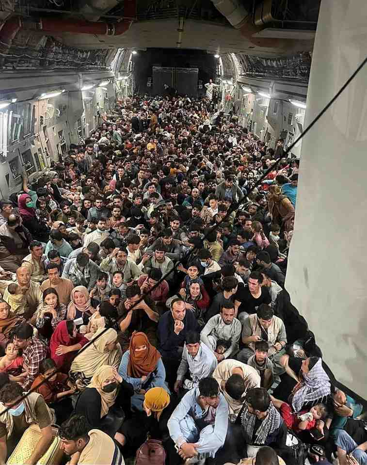 Crowded airplane cabin filled with Afghan refugees.