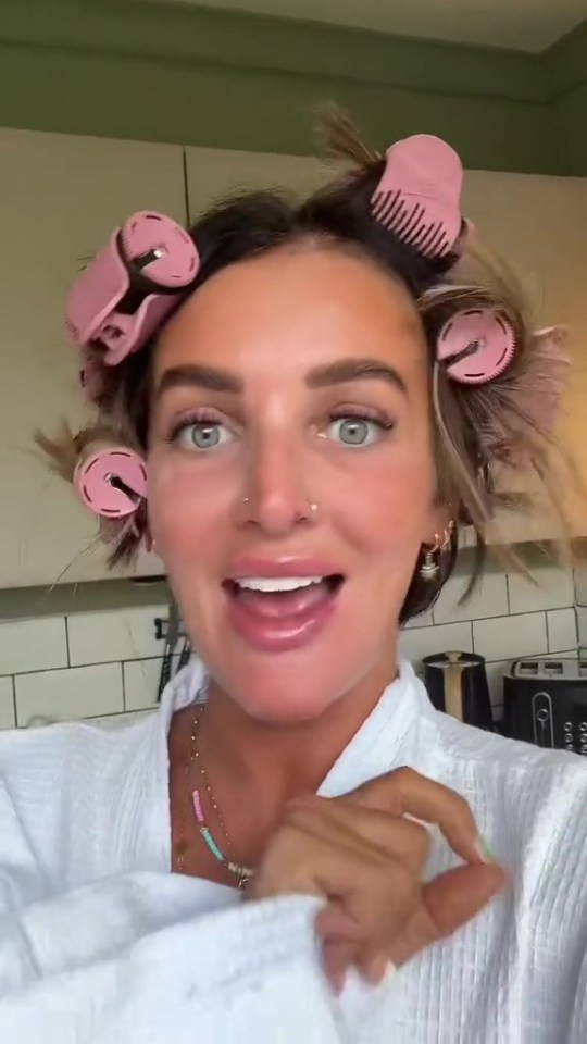 Woman with hair rollers demonstrates eye cream results.