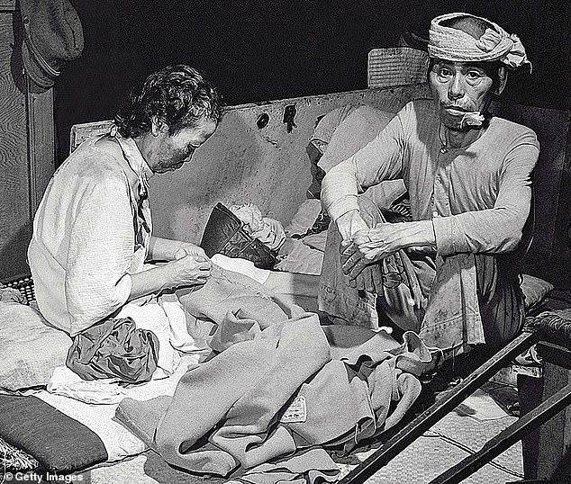Survivors of the US attack sit in a makeshift hospital that was set up in a bank building in the ruined city