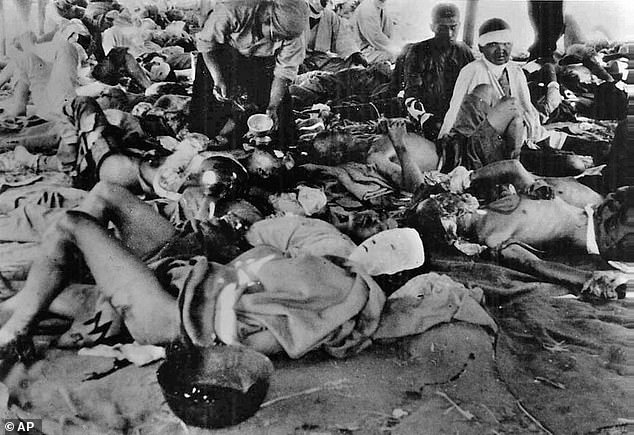 Survivors of the Hiroshima blast are seen lying in a tent relief center on the banks of the Ota River in the city, on August 7, 1945