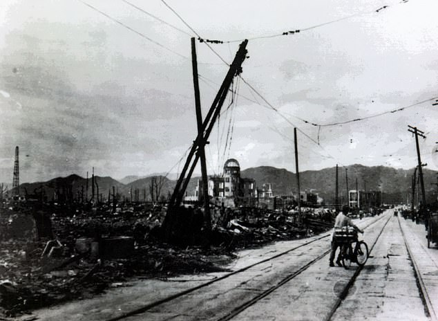 A man wheels his bike through the wreckage of Hiroshima after the atomic bomb blast
