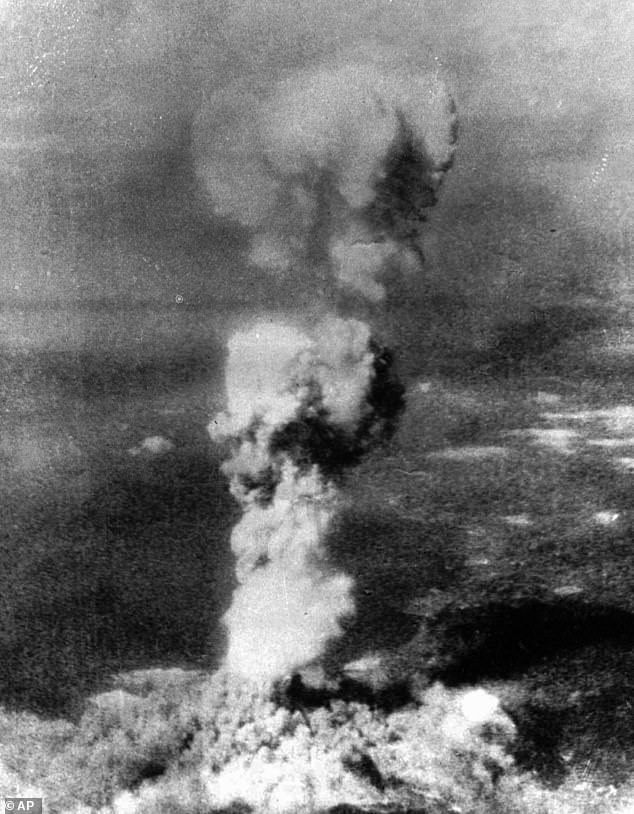 The huge column of smoke rising above Hiroshima, pictured from the air on August 6, 1945