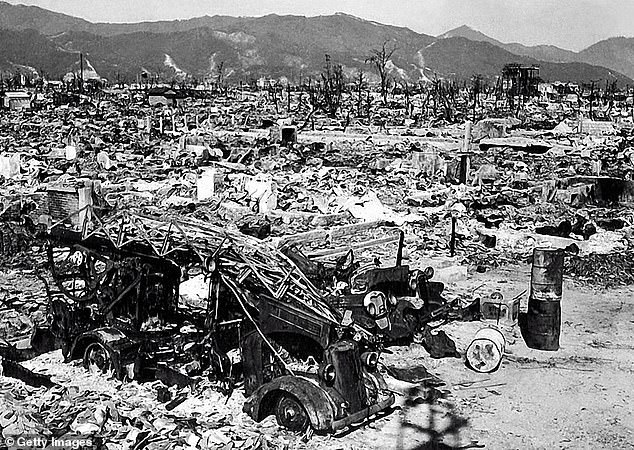 The remains of the only ladder truck of the Hiroshima fire department are seen in the foreground after the bombing of the city by the United States
