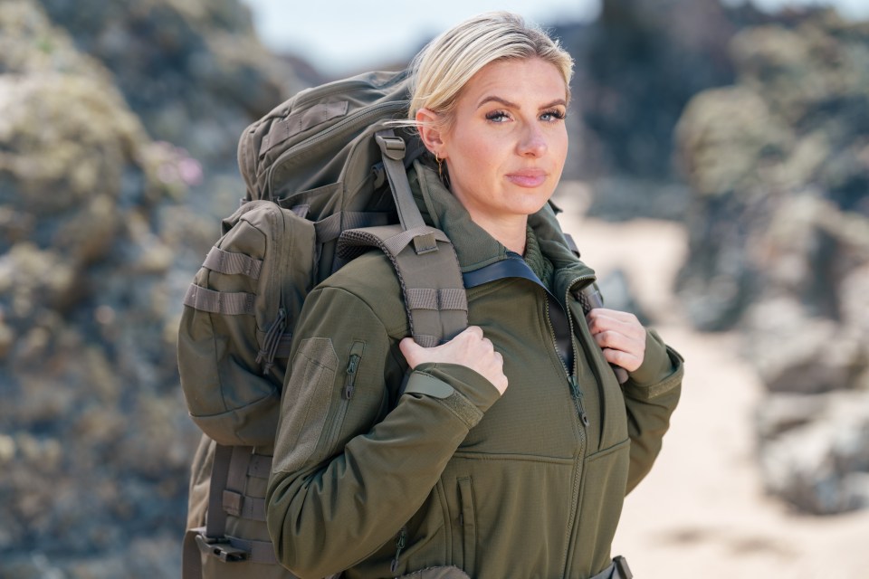 Woman with backpack on beach.