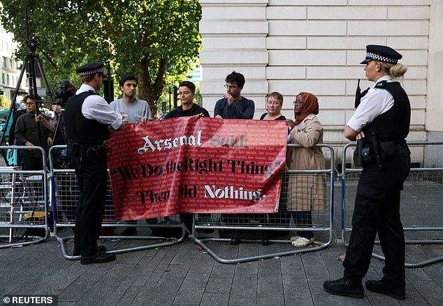People from the Arsenal Supporters Against Sexual Violence Group gathered with this banner