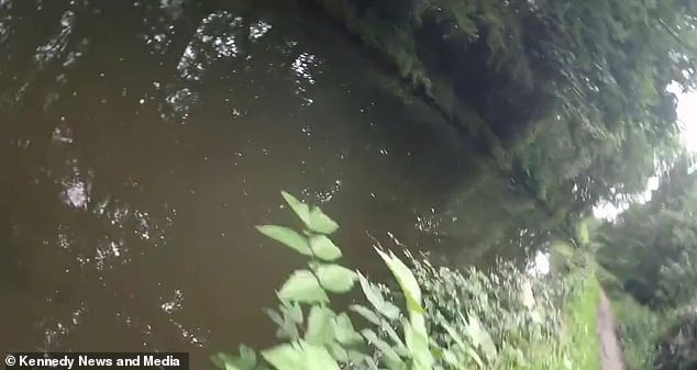 The camera then shows Ms Mitura plunge into the canal after being shoved, prompting immediate panic as she was still strapped to her bike pedals