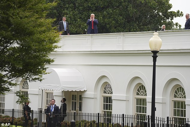 President Donald Trump is seen shouting to reporters from the roof of the West Wing over where the White House press briefing room is located