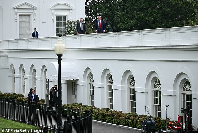 President Donald Trump told reporters he was taking a 'walk' and also joked that he was installing 'nuclear missiles' on the roof of the press briefing room