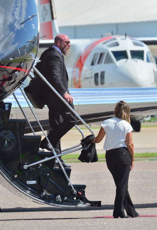 Triple H and Stephanie McMahon arriving at an airport.